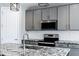 Close up of an eat-in kitchen featuring an island with granite countertops and stainless steel appliances at 35733 W Santa Monica Ave, Maricopa, AZ 85138