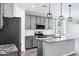 Well-equipped eat-in kitchen featuring an island with granite counters, stainless appliances, and stylish pendant lighting at 35733 W Santa Monica Ave, Maricopa, AZ 85138