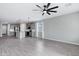 Open floorplan with a living room and an eat-in kitchen, highlighted by wood-look flooring and gray walls at 35733 W Santa Monica Ave, Maricopa, AZ 85138