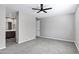 Spacious main bedroom with carpet, ceiling fan and bathroom area with double sink vanity at 35733 W Santa Monica Ave, Maricopa, AZ 85138