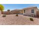 View of the backyard with desert landscaping and a block wall with privacy at 4992 E Rhodium Dr, San Tan Valley, AZ 85143