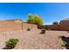 A low maintenance backyard featuring desert landscaping with a block wall and privacy at 4992 E Rhodium Dr, San Tan Valley, AZ 85143