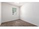 Small carpeted bedroom featuring a bright window and neutral walls at 4992 E Rhodium Dr, San Tan Valley, AZ 85143