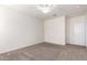 Carpeted bedroom featuring a ceiling fan, a window, and a white door at 4992 E Rhodium Dr, San Tan Valley, AZ 85143