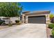 Inviting single-story home with a well-kept driveway and a two-car garage on a sunny day at 4992 E Rhodium Dr, San Tan Valley, AZ 85143