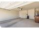 Large garage space with a door to the house, a water heater, and storage shelves at 4992 E Rhodium Dr, San Tan Valley, AZ 85143