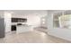 Modern kitchen features stainless steel appliances, dark cabinets, and an island with a breakfast bar at 4992 E Rhodium Dr, San Tan Valley, AZ 85143