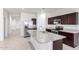 Modern kitchen with stainless steel appliances, granite countertops, and a stylish island with a sink at 4992 E Rhodium Dr, San Tan Valley, AZ 85143