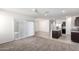 Open-concept living space with plush carpeting, large windows, and seamless transition to the modern kitchen at 4992 E Rhodium Dr, San Tan Valley, AZ 85143