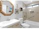 Bathroom featuring a vanity with a wooden-framed mirror and a tiled shower and bath at 15391 W Yucatan Dr, Surprise, AZ 85379