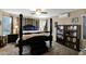 Main bedroom featuring a four poster bed, ceiling fan, and shelving units at 15391 W Yucatan Dr, Surprise, AZ 85379