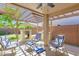 Inviting covered patio featuring an outdoor fireplace, built-in grill, and cozy seating for relaxation at 15391 W Yucatan Dr, Surprise, AZ 85379
