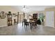 Dining room with wood floors, dining table, display cabinet and sliding glass doors to patio at 15391 W Yucatan Dr, Surprise, AZ 85379