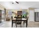 Open dining room with wood flooring, dining table and chairs, and sliding glass door at 15391 W Yucatan Dr, Surprise, AZ 85379