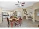 Dining room area with wood table and chairs, view into kitchen and decorated walls at 15391 W Yucatan Dr, Surprise, AZ 85379