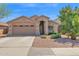 Charming single-story home featuring a well-maintained front yard with desert landscaping and a two-car garage at 15391 W Yucatan Dr, Surprise, AZ 85379