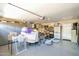 Spacious garage interior with ample storage, including cabinets, shelving, and room for various items and activities at 15391 W Yucatan Dr, Surprise, AZ 85379
