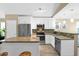 Bright, modern kitchen with stainless steel appliances, granite countertops, and a center island at 15391 W Yucatan Dr, Surprise, AZ 85379