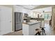 Bright, modern kitchen with stainless steel appliances, granite countertops, and a center island at 15391 W Yucatan Dr, Surprise, AZ 85379