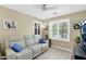 Cozy living room with wood-look tile floors, neutral paint, and lots of natural light from the windows at 15391 W Yucatan Dr, Surprise, AZ 85379