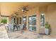 Comfortable outdoor living space with ceiling fans and flagstone flooring, accessible through sliding glass doors at 16183 W Monterey Way, Goodyear, AZ 85395