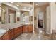 Primary bathroom featuring dual sinks, granite countertops, large mirror and tiled flooring at 22635 N 54Th Pl, Phoenix, AZ 85054
