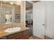 Well-lit bathroom featuring a single sink, granite countertops, and a large mirror at 22635 N 54Th Pl, Phoenix, AZ 85054