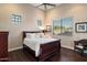 Cozy bedroom featuring a queen-size bed, natural light, and hardwood floors at 22635 N 54Th Pl, Phoenix, AZ 85054