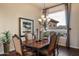 Elegant dining room featuring a wood table, cushioned chairs, and a large window with natural light at 22635 N 54Th Pl, Phoenix, AZ 85054