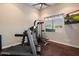 Exercise room featuring wood floors, TV, and an exercise machine by a large window at 22635 N 54Th Pl, Phoenix, AZ 85054