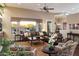 Spacious living room with a plush leather sofa, decorative accents, and large windows offering outdoor views at 22635 N 54Th Pl, Phoenix, AZ 85054