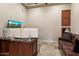 Well-lit office featuring a custom built-in desk, travertine floors and a comfortable leather couch at 22635 N 54Th Pl, Phoenix, AZ 85054