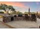 Outdoor kitchen with built-in grill, sink, and ample counter space for entertaining at 22635 N 54Th Pl, Phoenix, AZ 85054