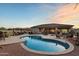Backyard oasis with a sparkling pool, outdoor kitchen, and expansive patio for relaxation and entertainment at 22635 N 54Th Pl, Phoenix, AZ 85054