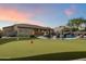 Lush backyard featuring a well-manicured putting green and a cozy patio area for outdoor enjoyment at 22635 N 54Th Pl, Phoenix, AZ 85054