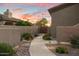 Charming walkway to the home entrance, accented with desert landscaping and warm lighting at 22635 N 54Th Pl, Phoenix, AZ 85054