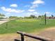Beautiful golf course view with lush green fairway and mature trees under a blue sky with fluffy clouds at 30374 N Sunray Dr, Queen Creek, AZ 85143