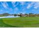 Picturesque golf course view with lush green fairway, water feature, and nearby homes in a serene community setting at 30374 N Sunray Dr, Queen Creek, AZ 85143