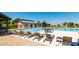 Community pool area with lounge chairs, tables, and well-maintained amenities for residents to enjoy in the sunshine at 30374 N Sunray Dr, Queen Creek, AZ 85143