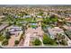 Beautiful home featuring a private pool, tennis court, mature landscaping, and a spacious front yard at 3356 E Vallejo Ct, Gilbert, AZ 85298