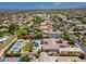 Aerial view of the property showcasing circular drive, mature landscaping, tennis court, private pool, and sport court at 3356 E Vallejo Ct, Gilbert, AZ 85298