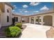 Spacious backyard features a covered patio, fireplace, and an arched gate at 3356 E Vallejo Ct, Gilbert, AZ 85298
