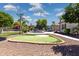 Landscaped backyard showcases a putting green, pool and tennis court at 3356 E Vallejo Ct, Gilbert, AZ 85298