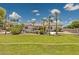 Expansive backyard with lush landscaping, palm trees, pool, and patio furniture at 3356 E Vallejo Ct, Gilbert, AZ 85298