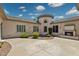 Beautiful backyard with stucco exterior, fireplace, manicured landscaping and a paver circular driveway at 3356 E Vallejo Ct, Gilbert, AZ 85298