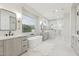 Bright bathroom featuring dual vanities, soaking tub with window view, and glass-enclosed shower at 3356 E Vallejo Ct, Gilbert, AZ 85298