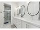 Bathroom featuring a double vanity with white countertops and modern lighting fixtures at 3356 E Vallejo Ct, Gilbert, AZ 85298