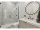 Stylish bathroom with glass-enclosed shower, modern vanity, and unique tiled wall at 3356 E Vallejo Ct, Gilbert, AZ 85298