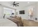 Spacious bedroom features seating area, ceiling fan, wood floors, and ample sunlight at 3356 E Vallejo Ct, Gilbert, AZ 85298
