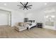 Cozy bedroom showcases wood floors, ceiling fan, seating area, and tranquil ambiance at 3356 E Vallejo Ct, Gilbert, AZ 85298